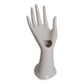 Hand holds white jewelry, ring sizer