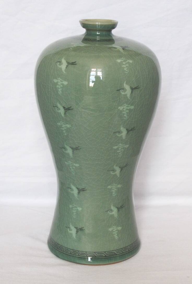 Korean vase in crackled celadon with a pattern of ducks and clouds.