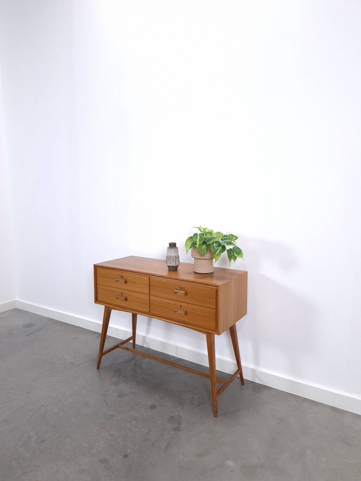 Vintage teak Danish chest of drawers with high slanted legs, side table, sideboard.