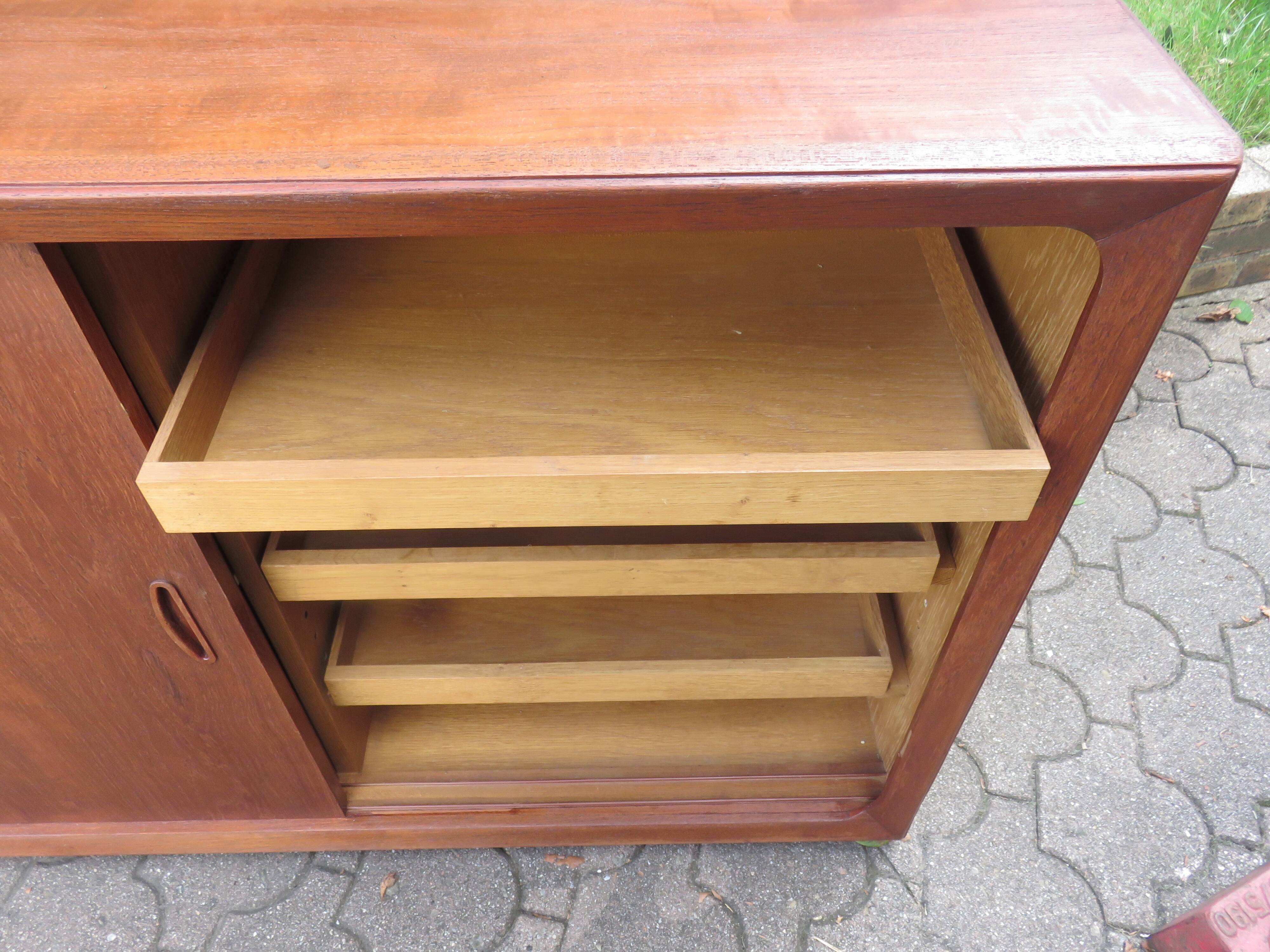 Low sideboard with 3 sliding doors in teak. Denmark 1960