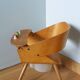 Baumann Baby Coquille children's armchair in bent wood with splayed legs.