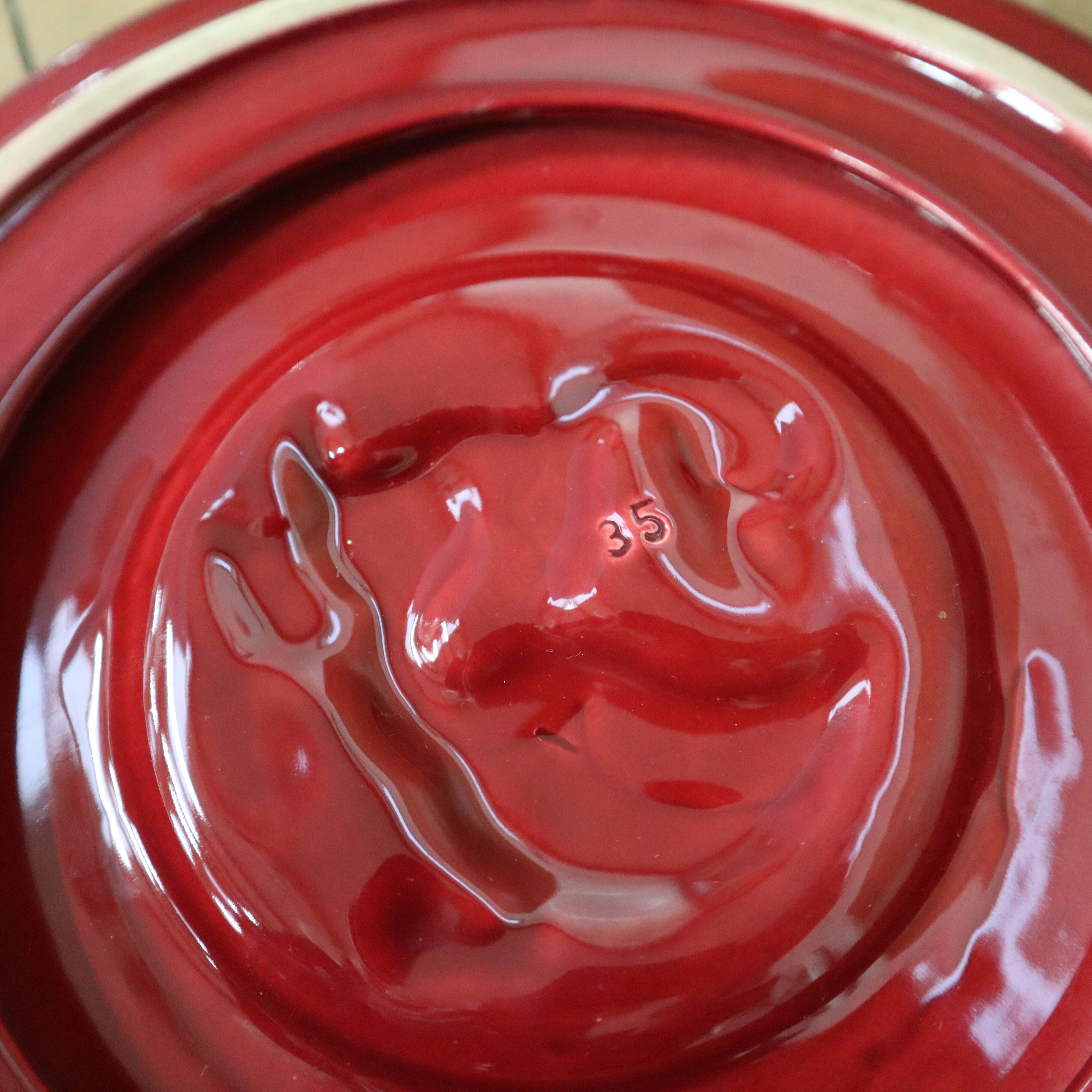 Vintage burgundy duck trivet with gold edging