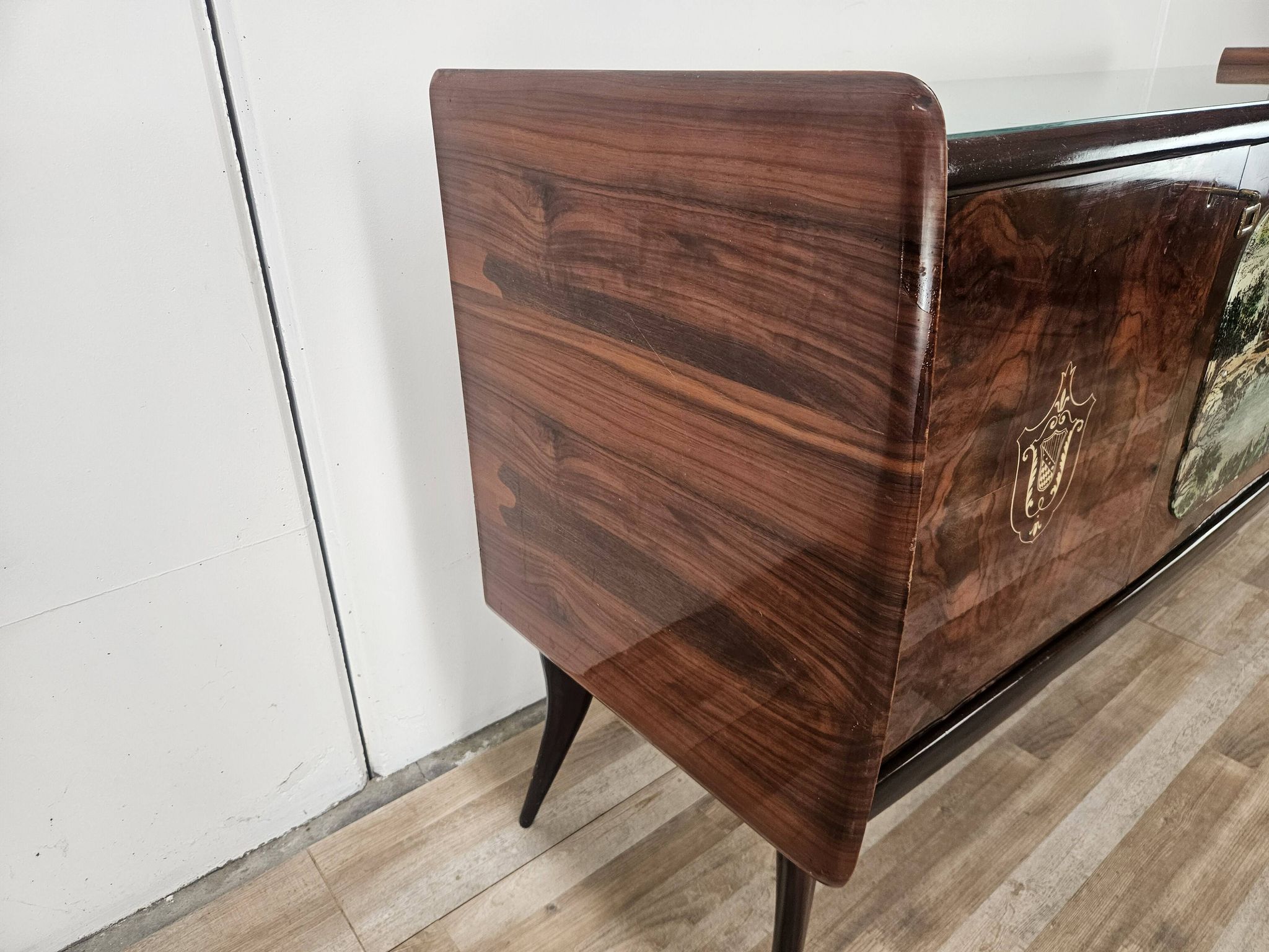 1950s mahogany sideboard with a glass top and central bar.