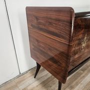 1950s mahogany sideboard with a glass top and central bar.