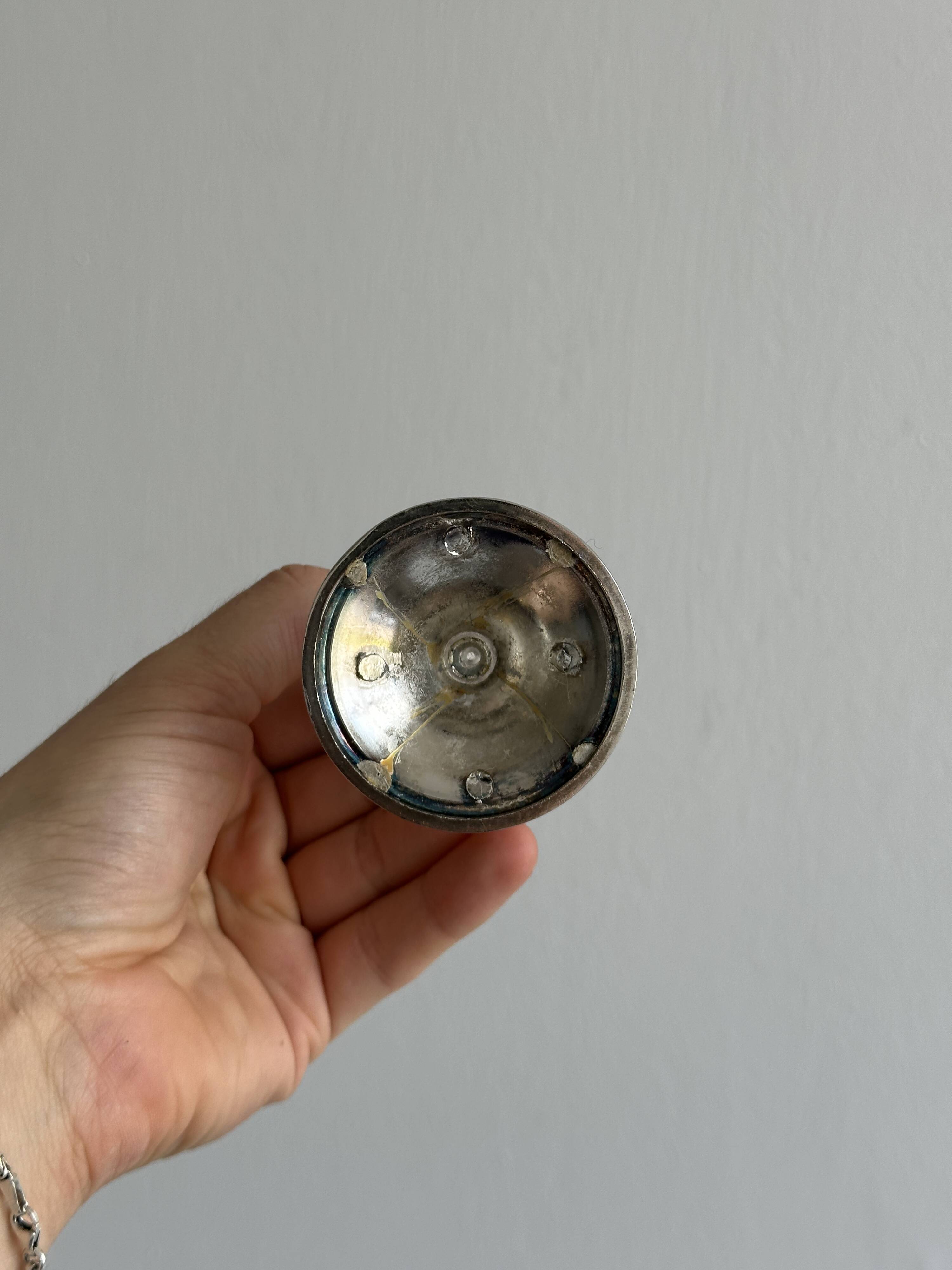 Small shiny metal candle holder