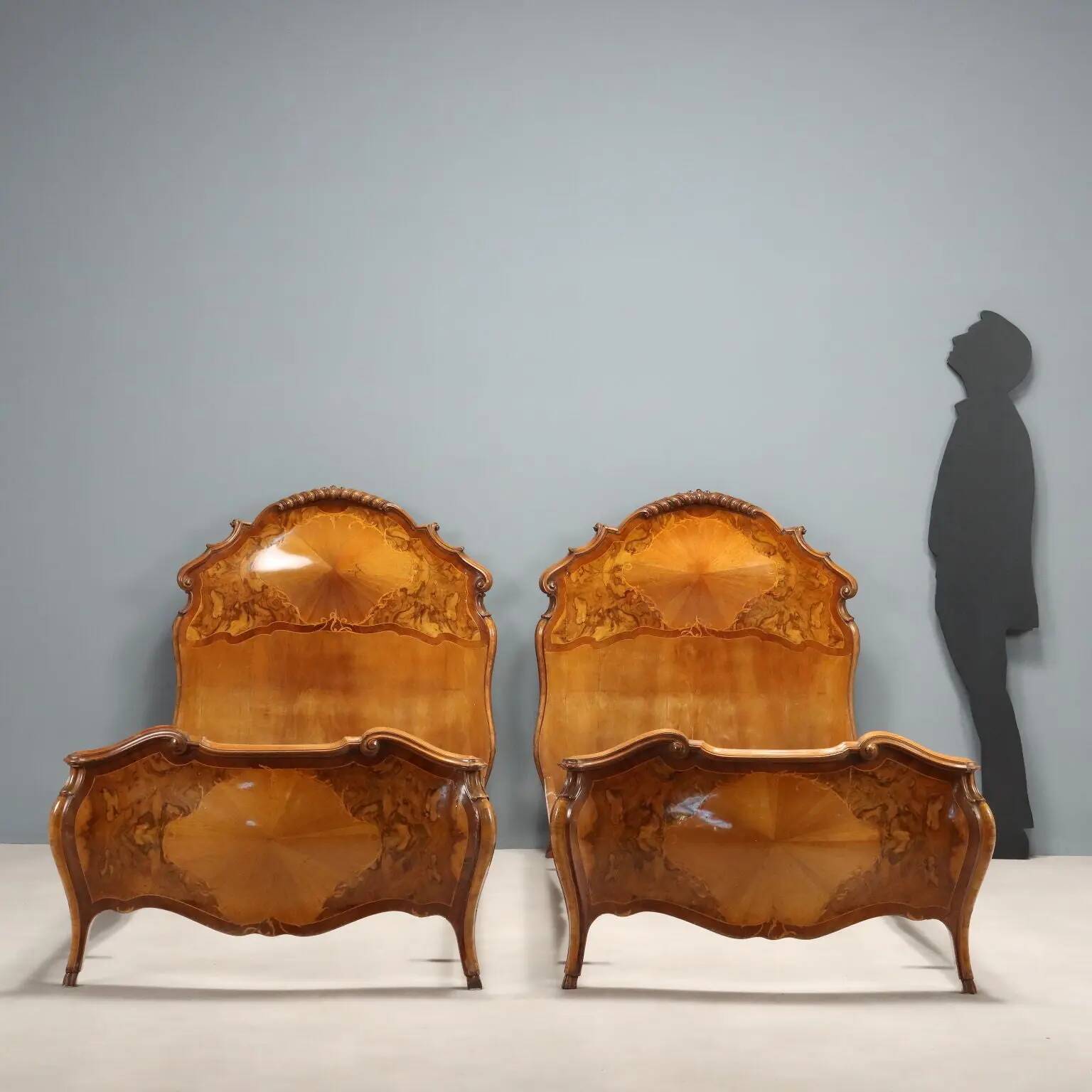 Simple old baroque-style beds in various woods from the 20th century.