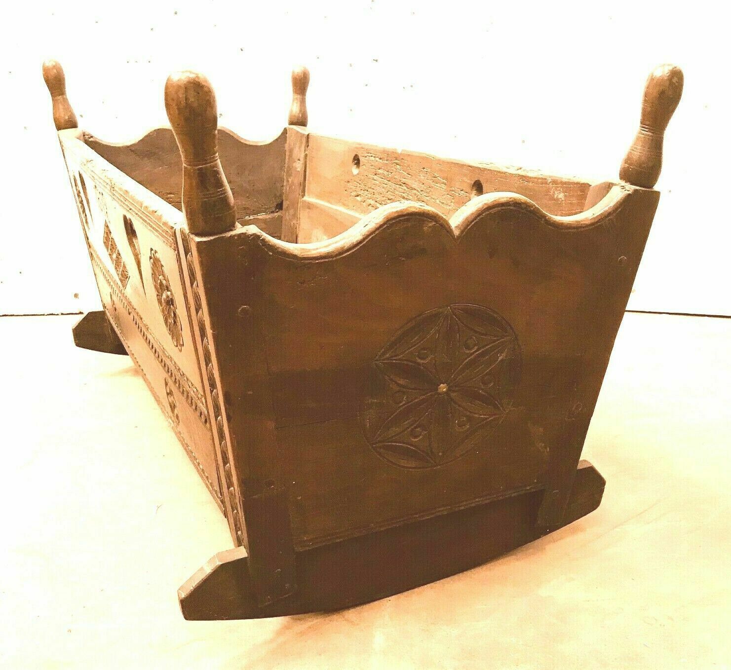 Sculpted walnut rocking cradle