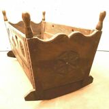 Sculpted walnut rocking cradle