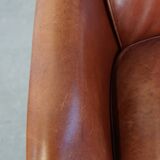 Cowhide armchair in good condition, finished with decorative nails
