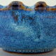 Cut or pocket in polychrome varnished sandstone with a blue and floral decoration