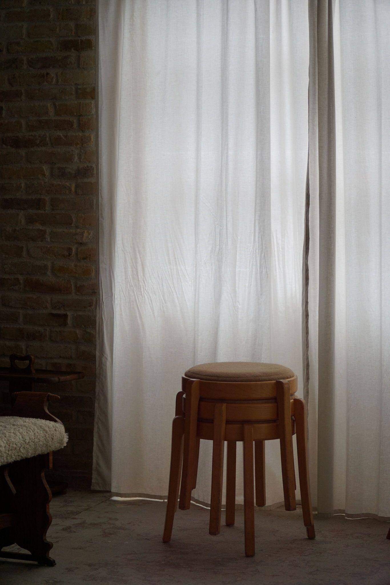 Modern Swedish, set of 14 stackable stools in birch and hessian fabric, 1980s.