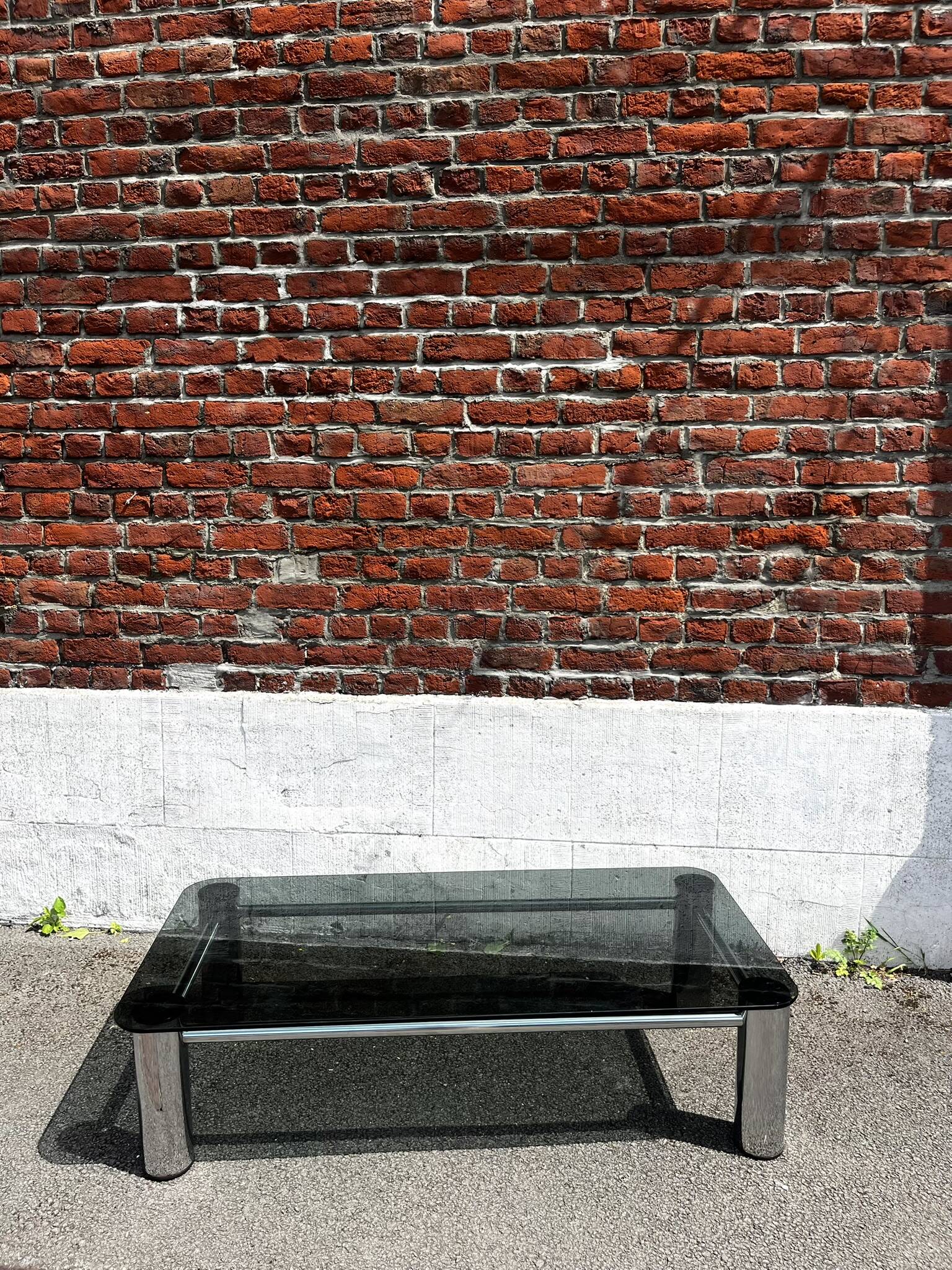 Vintage coffee table with smoked glass and chrome.