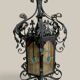 Black wrought iron lantern with stained glass. Medieval, Gothic decoration.