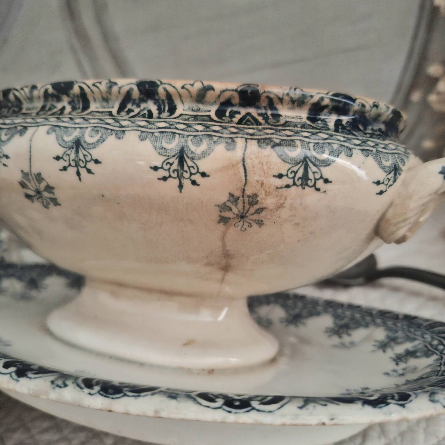 Antique iron earthenware sauceboat on a frame