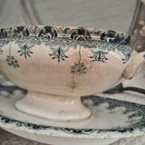 Old iron earthenware sauce boat on frame