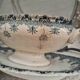 Antique iron earthenware sauceboat on a frame