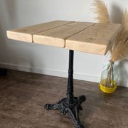 Bistro table with a central cast iron base in industrial style.