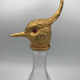 Glass bottle type carafe with gold metal bird head stopper