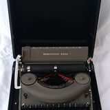 portable Remington typewriter with its suitcase and original cover