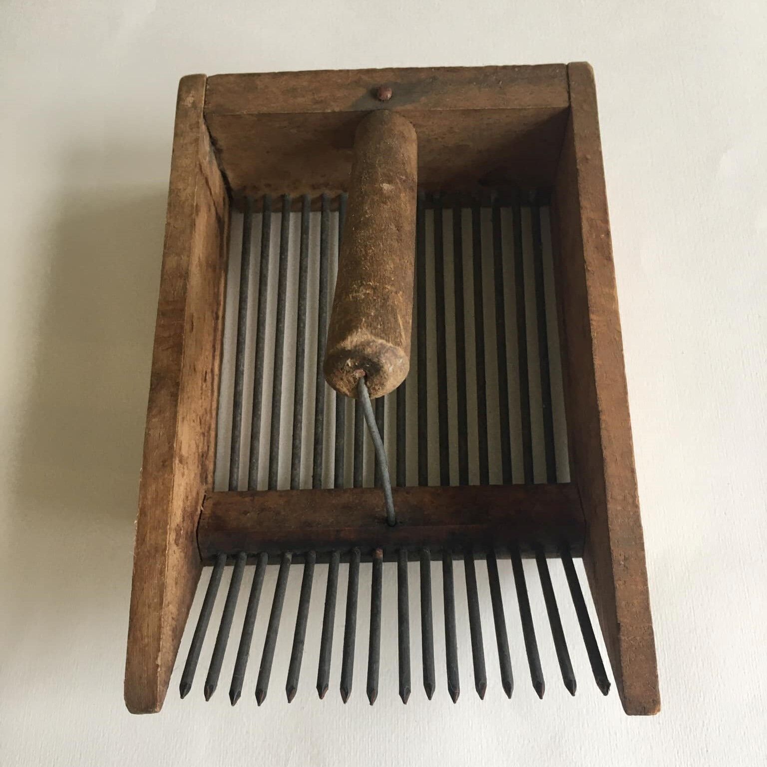 Old comb with berries (blueberries ..) in wood and metal
