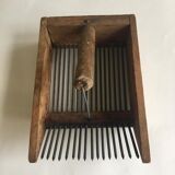 Old comb with berries (blueberries ..) in wood and metal