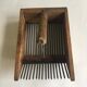 Old comb with berries (blueberries ..) in wood and metal