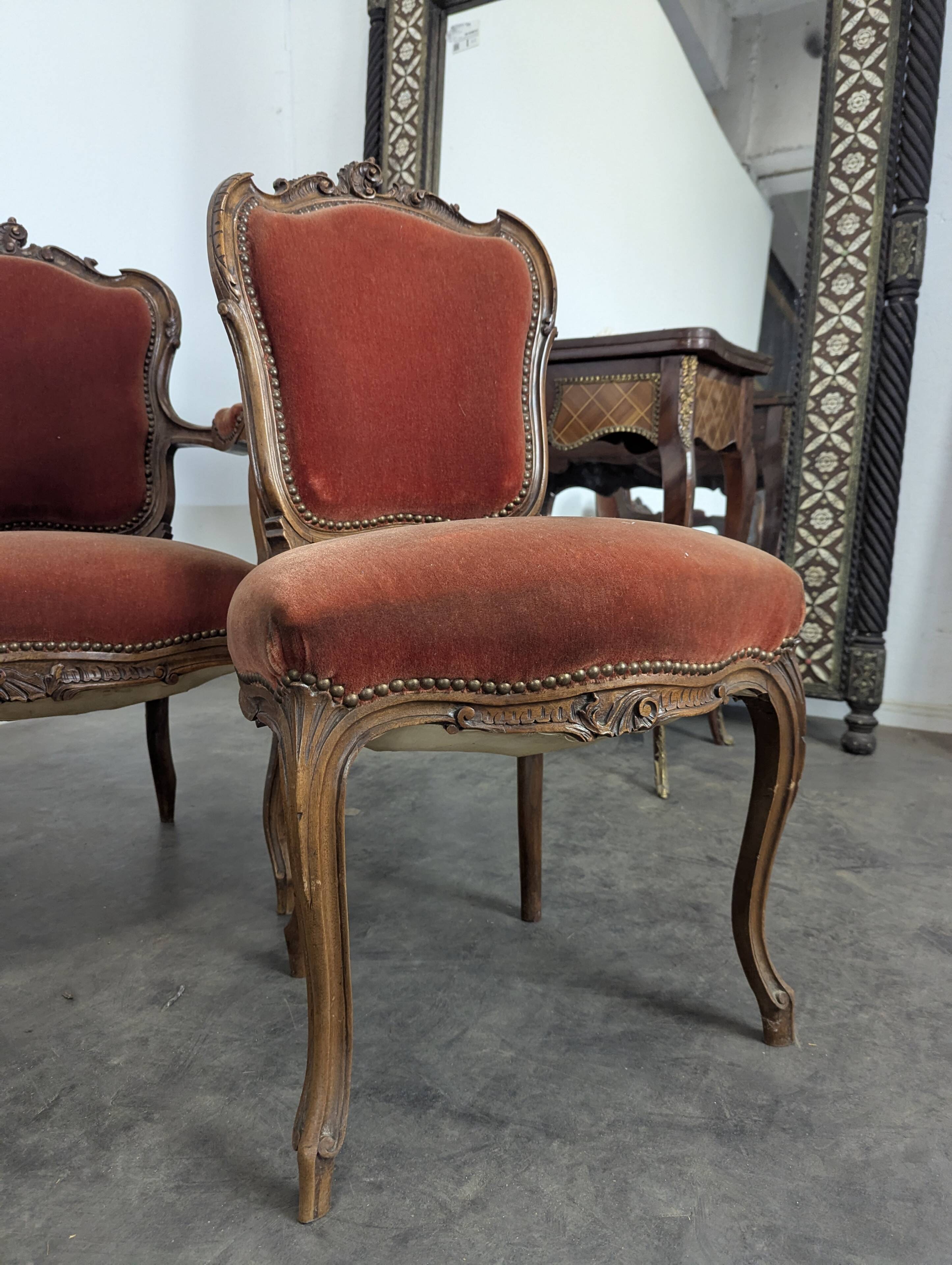 Louis XV style salon in carved walnut with orange velvet, seven pieces.