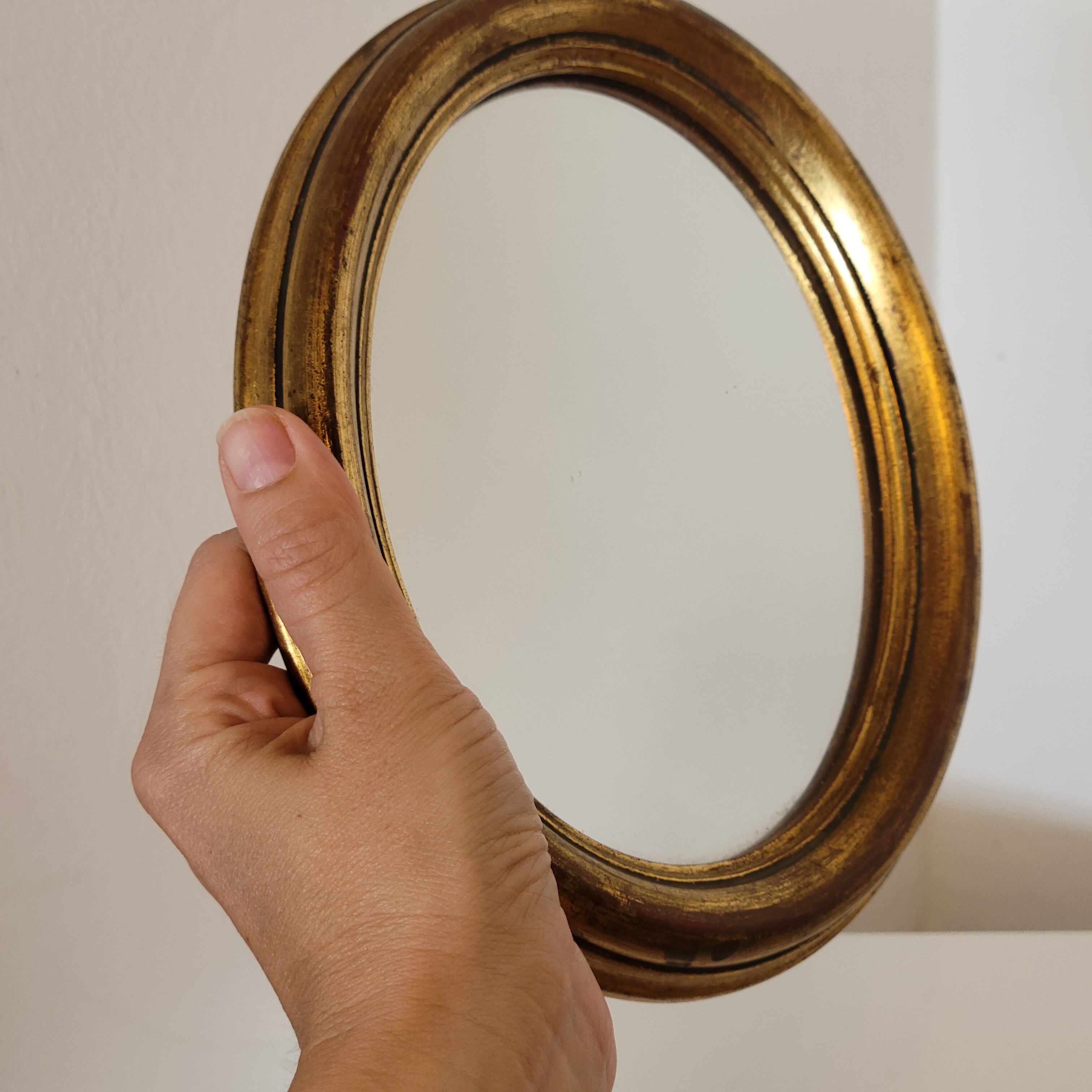 Old small oval mirror gilded wooden frame 22 X 17 X 2 cm.