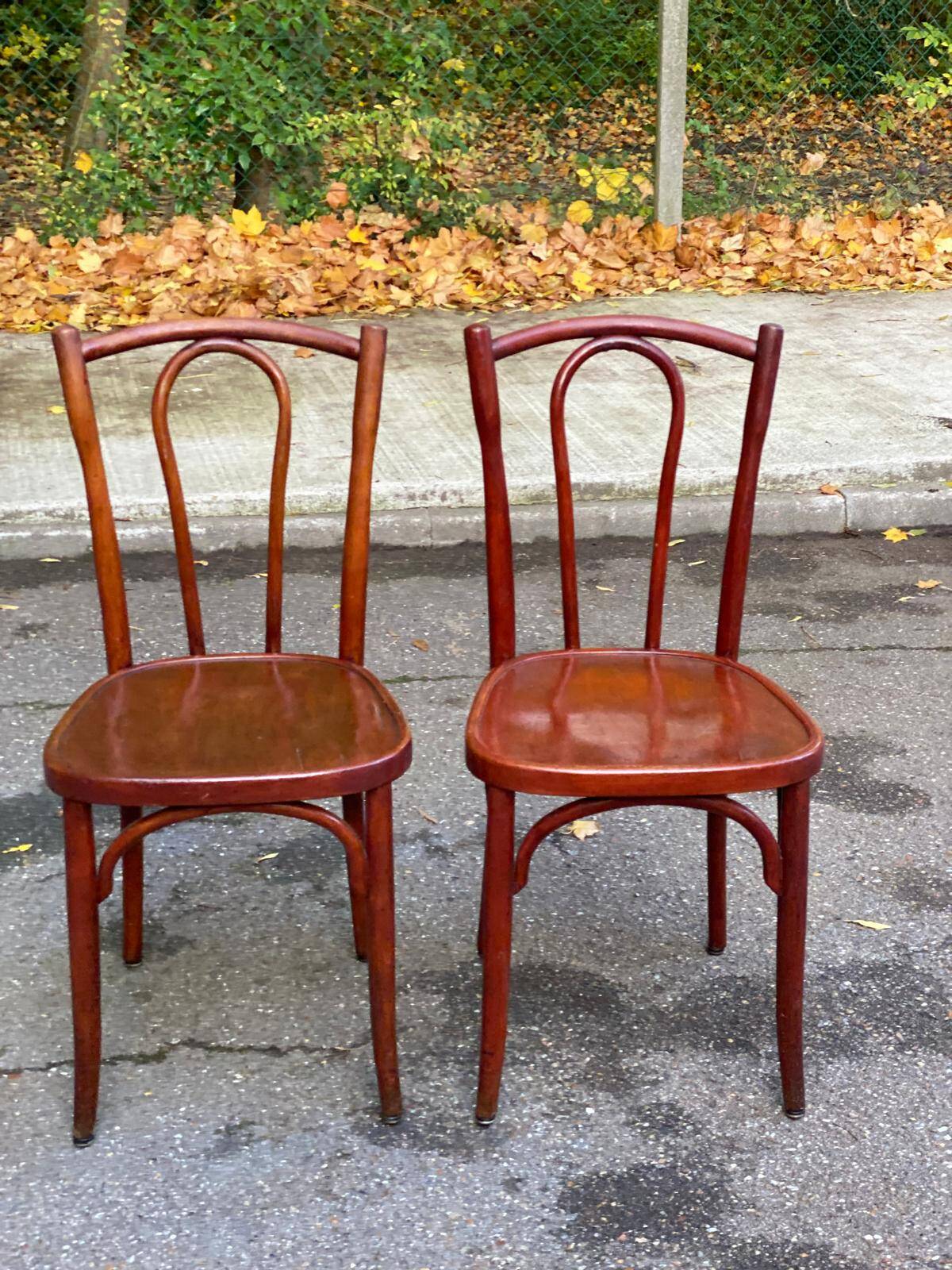 2 curved solid wood bistro chairs in Bordeaux.