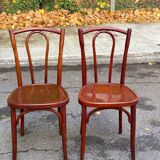 2 curved solid wood bistro chairs in Bordeaux.