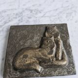 Bas-relief plaque of a rabbit in brown patina, seated cat