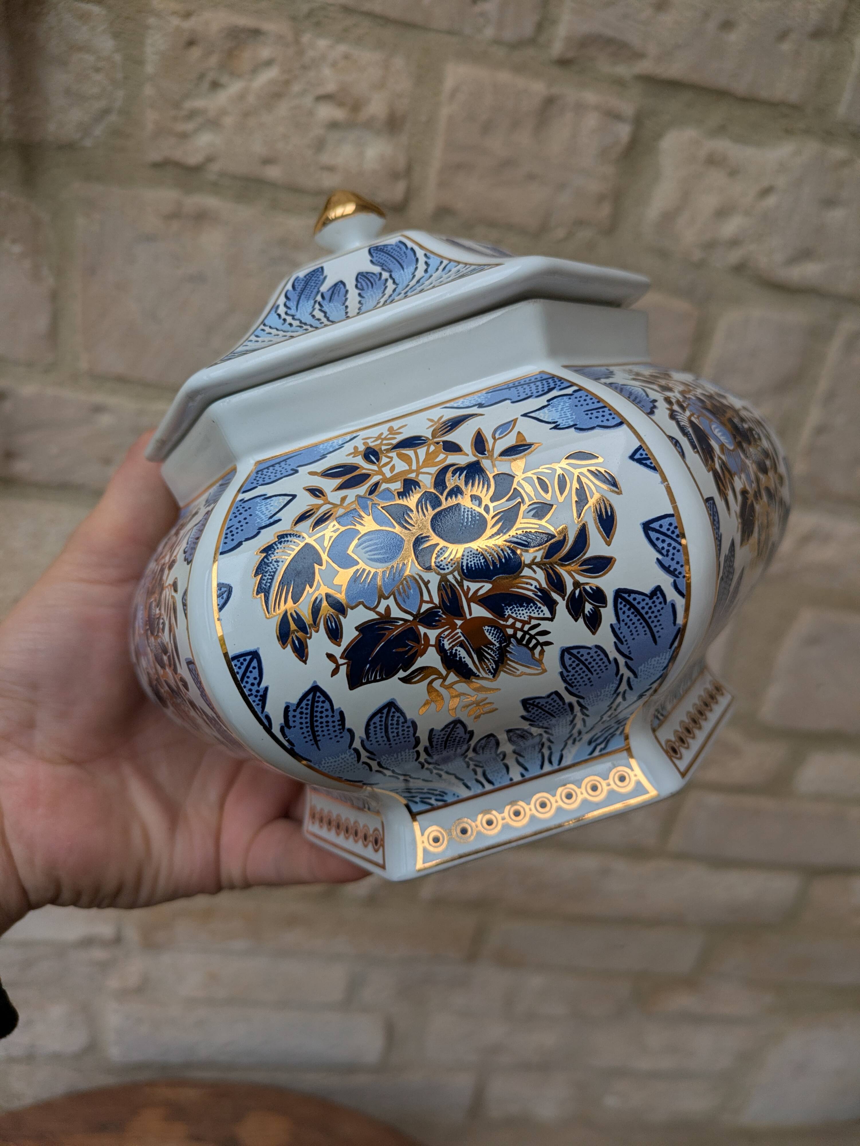Decorative pot jar with a lid featuring a blue floral pattern and gilding.