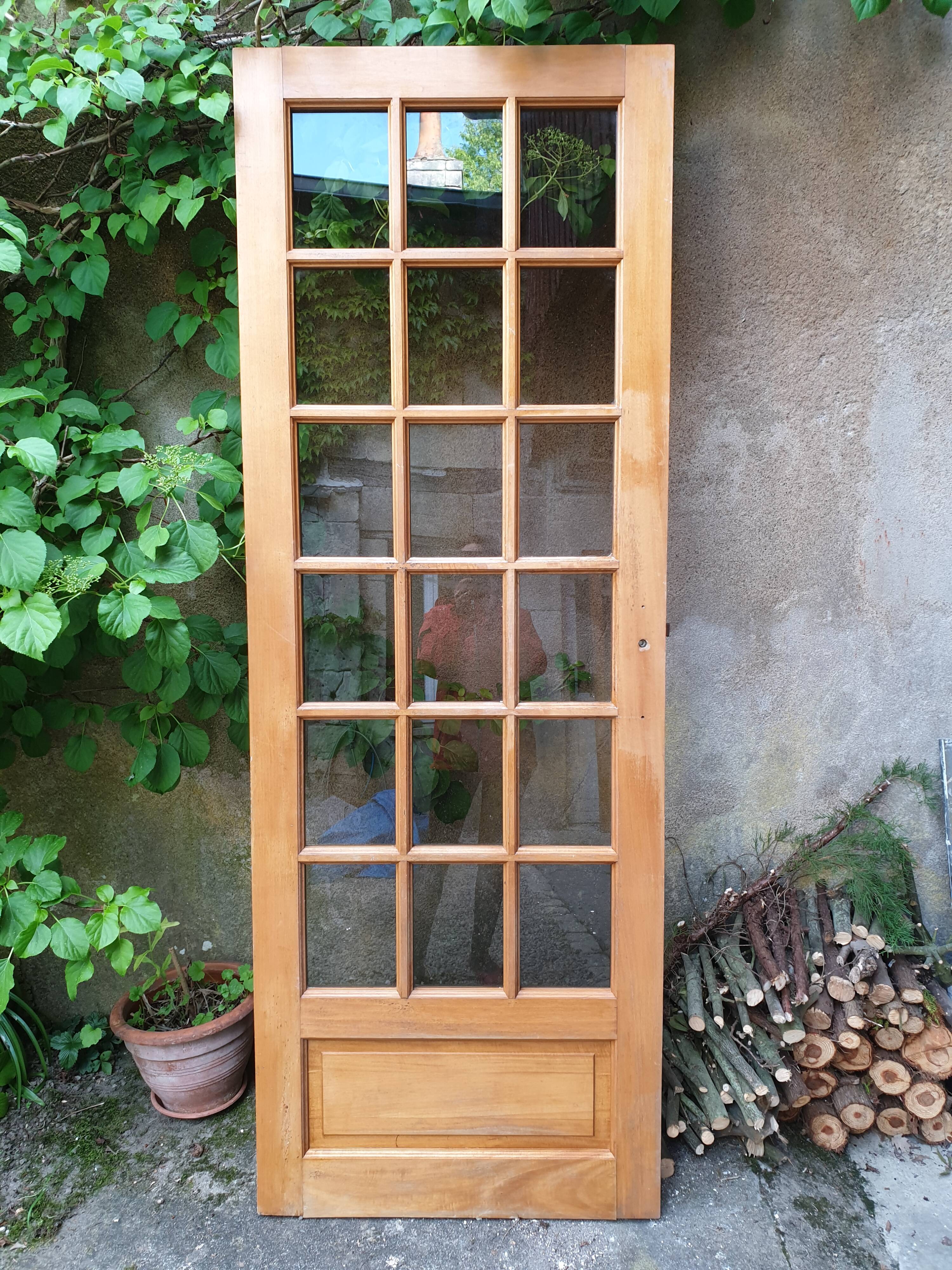 Old wooden door glazed with small tiles
