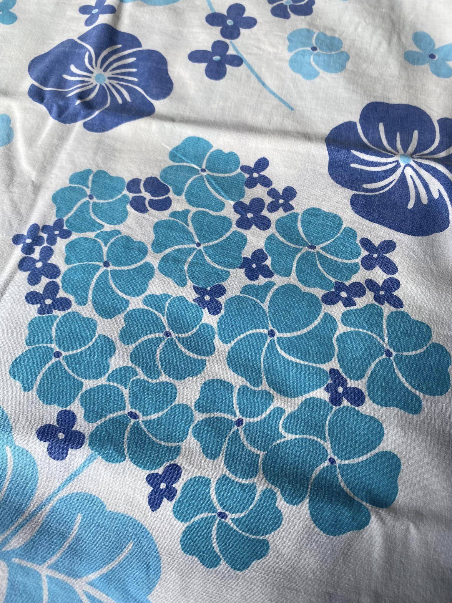 2 vintage cotton pillowcases with blue floral patterns.