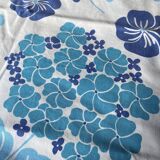 2 vintage cotton pillowcases with blue floral patterns.