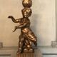 Two carved wooden children, table lamps.