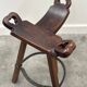 Set of 3 rustic carved oak bar stools with iron footrests, 1970s
