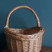 Handcrafted wicker basket with a handle.