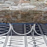 Oval table in smoked glass and metal foot