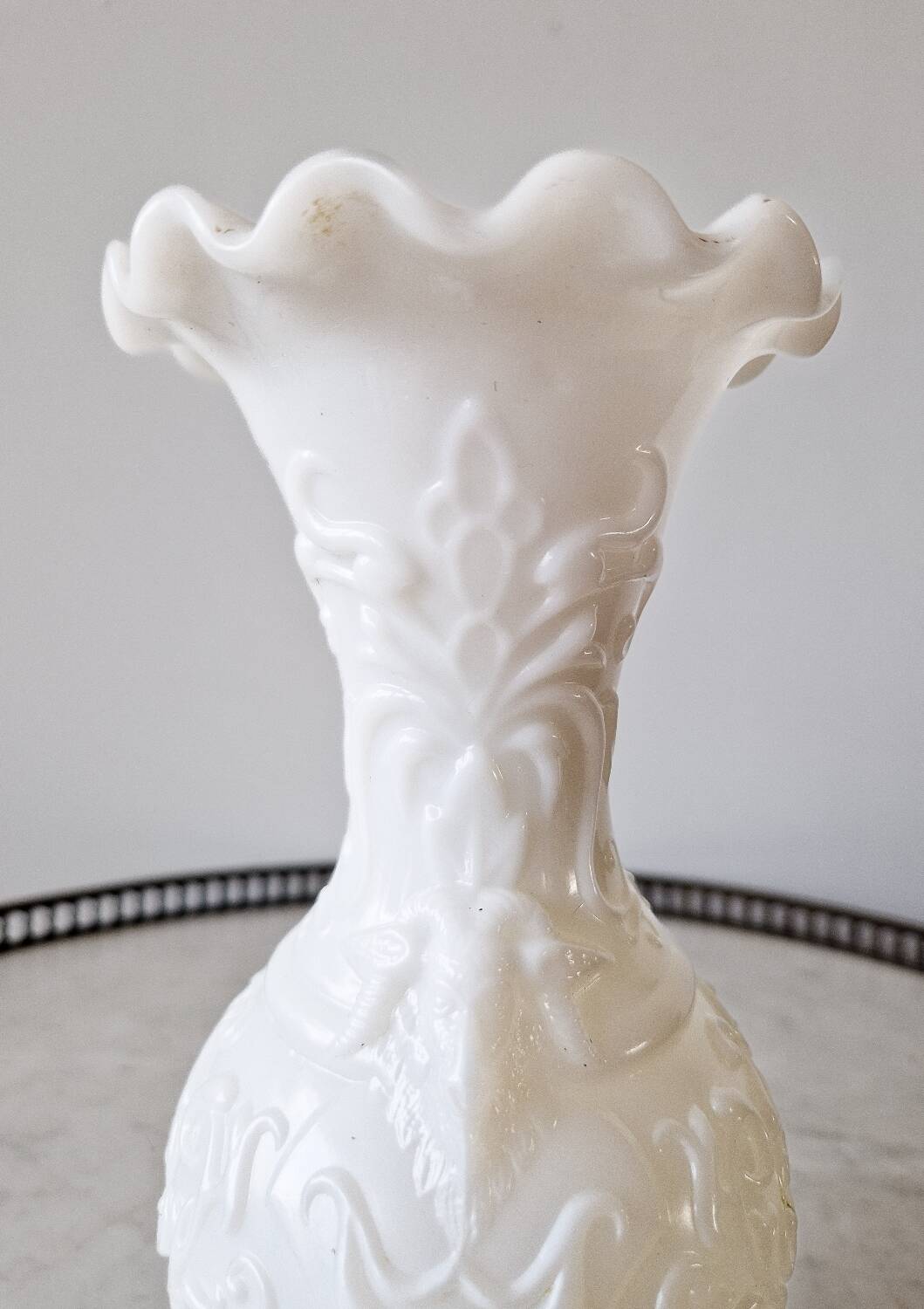 White opaline vase decorated with arabesques and ram's heads