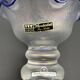 Eisch glass footed cup with pearlescent finish, blue rim.