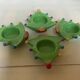 Four Christmas tree-shaped candle holders