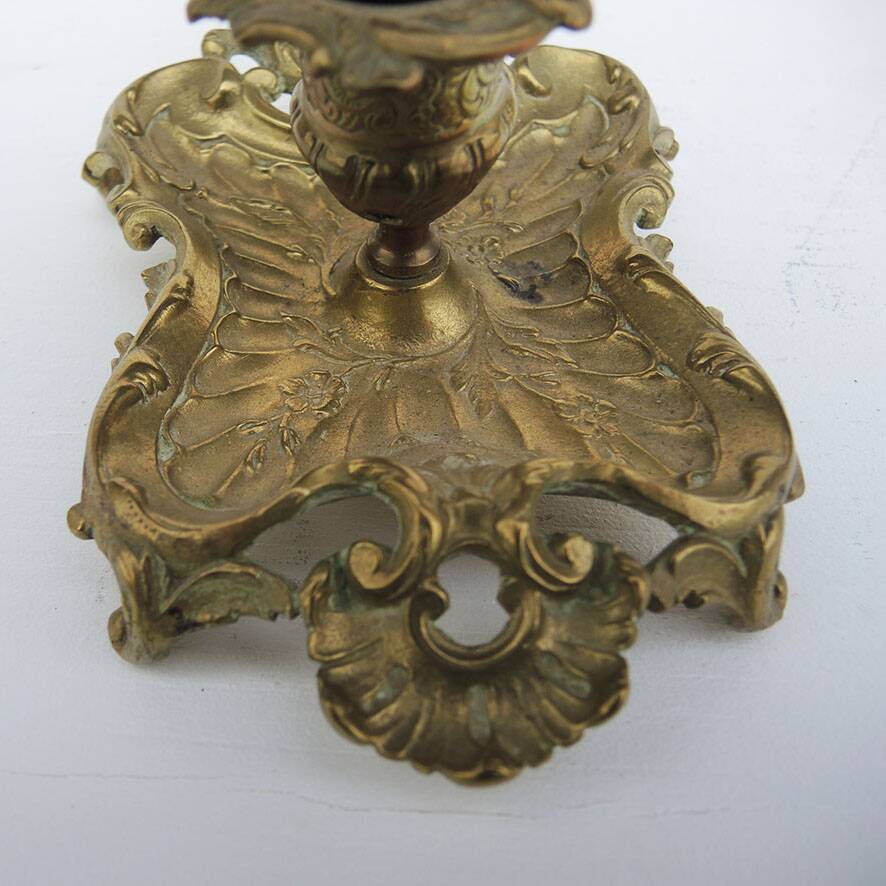 Antique rococo-style hand candlestick in bronze or brass