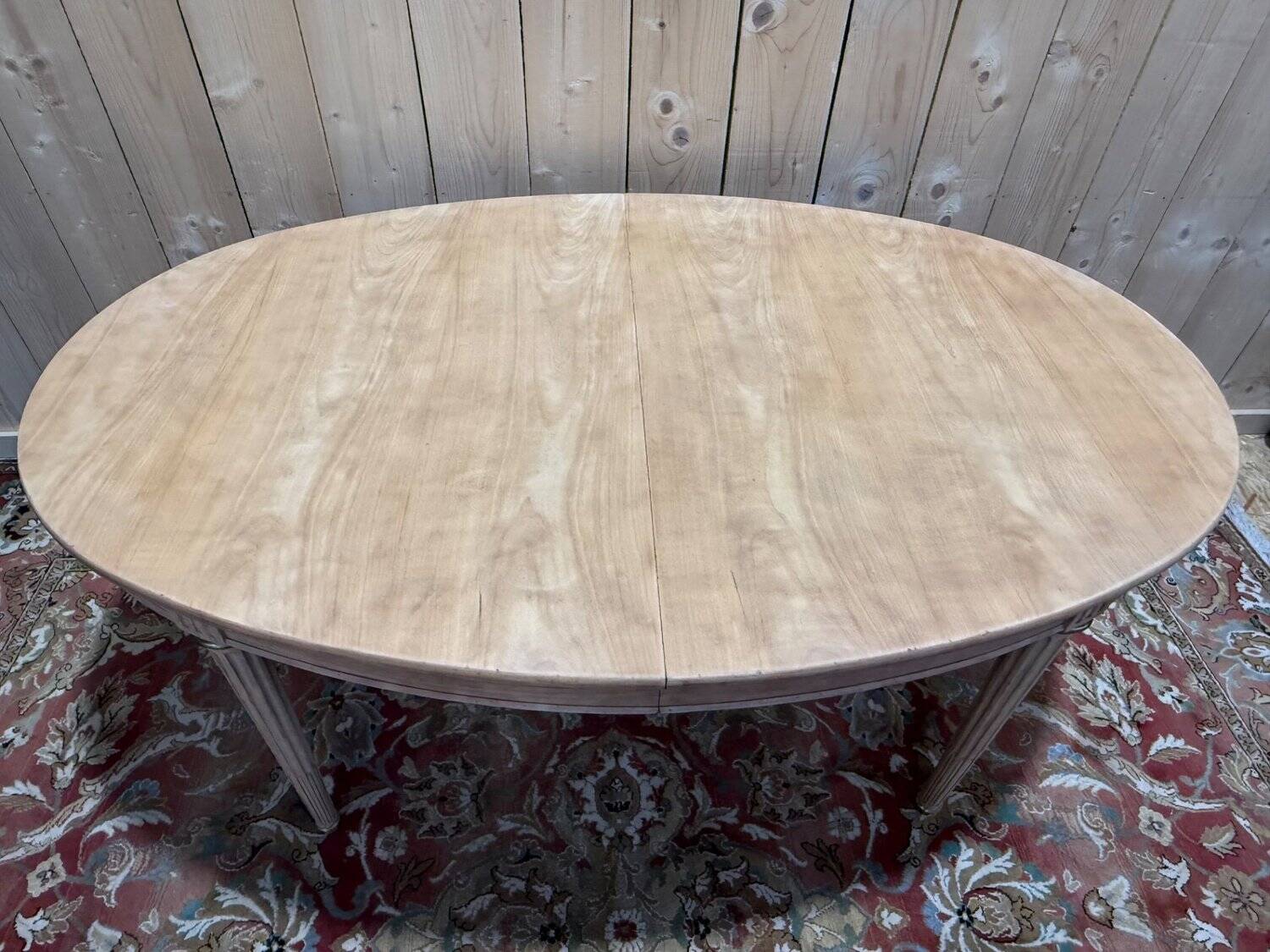 Oval Louis XVI dining table in cherry wood.