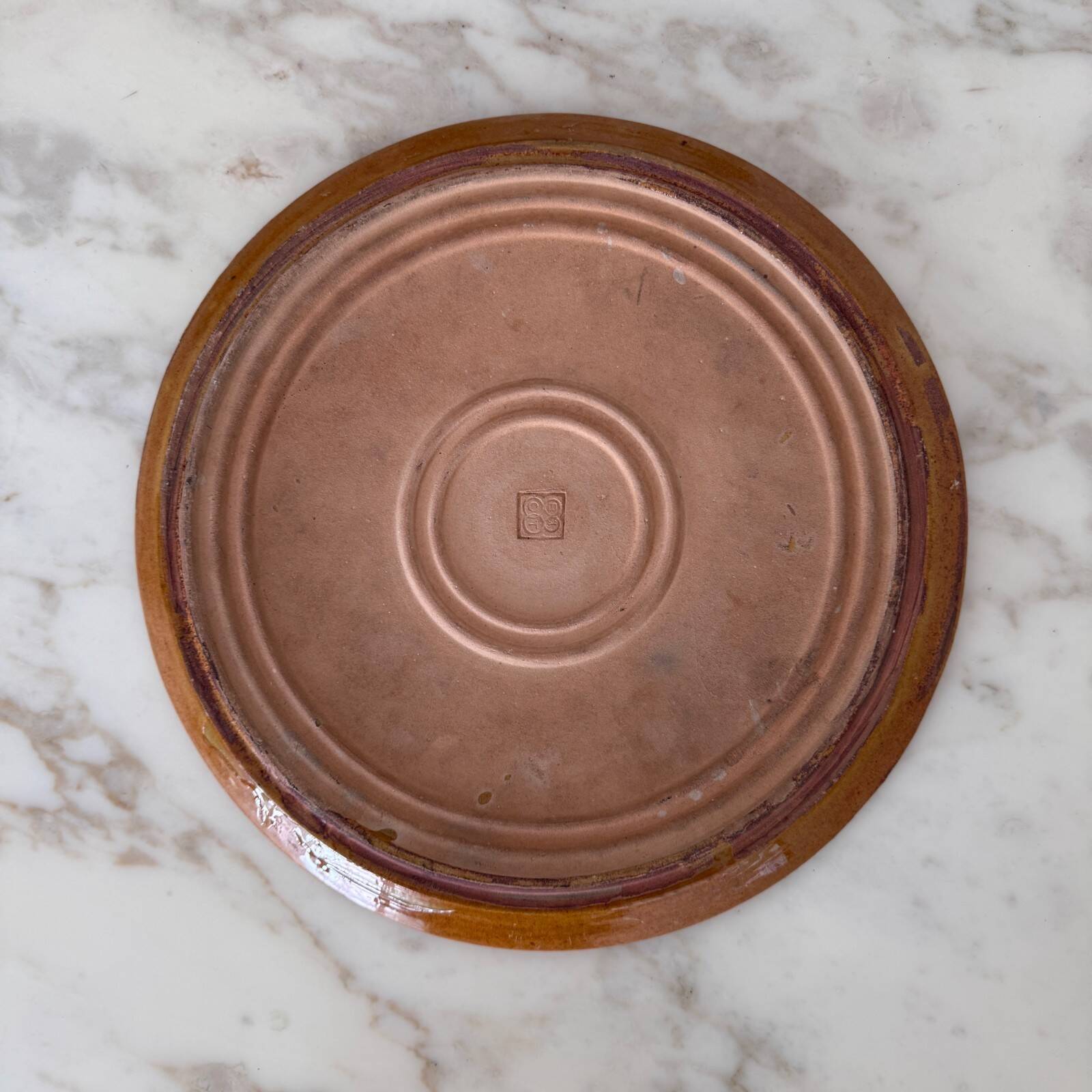 Round glazed earthenware dish by Biot, 20th century, stylized decoration