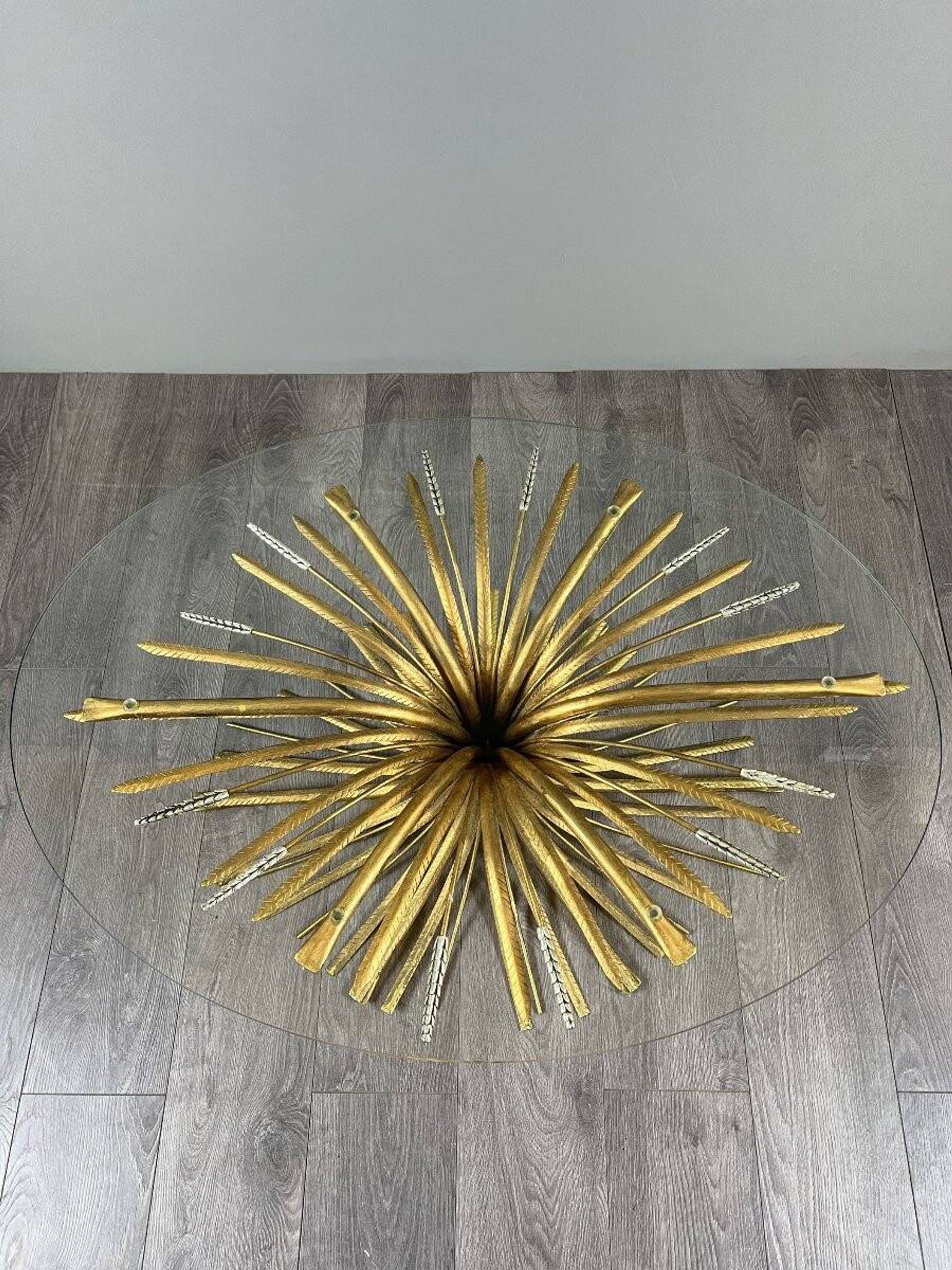 Gold metal and glass coffee table, 20th century, in the style of Robert Goos.