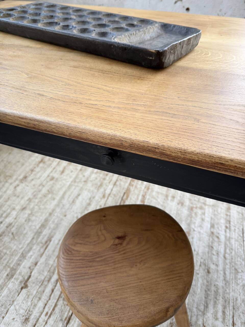 Oak farmhouse table with turned black legs.