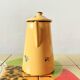 Old coffee maker in yellow enameled sheet metal - olive decor