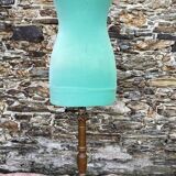 Old mannequin on wooden and fabric stand