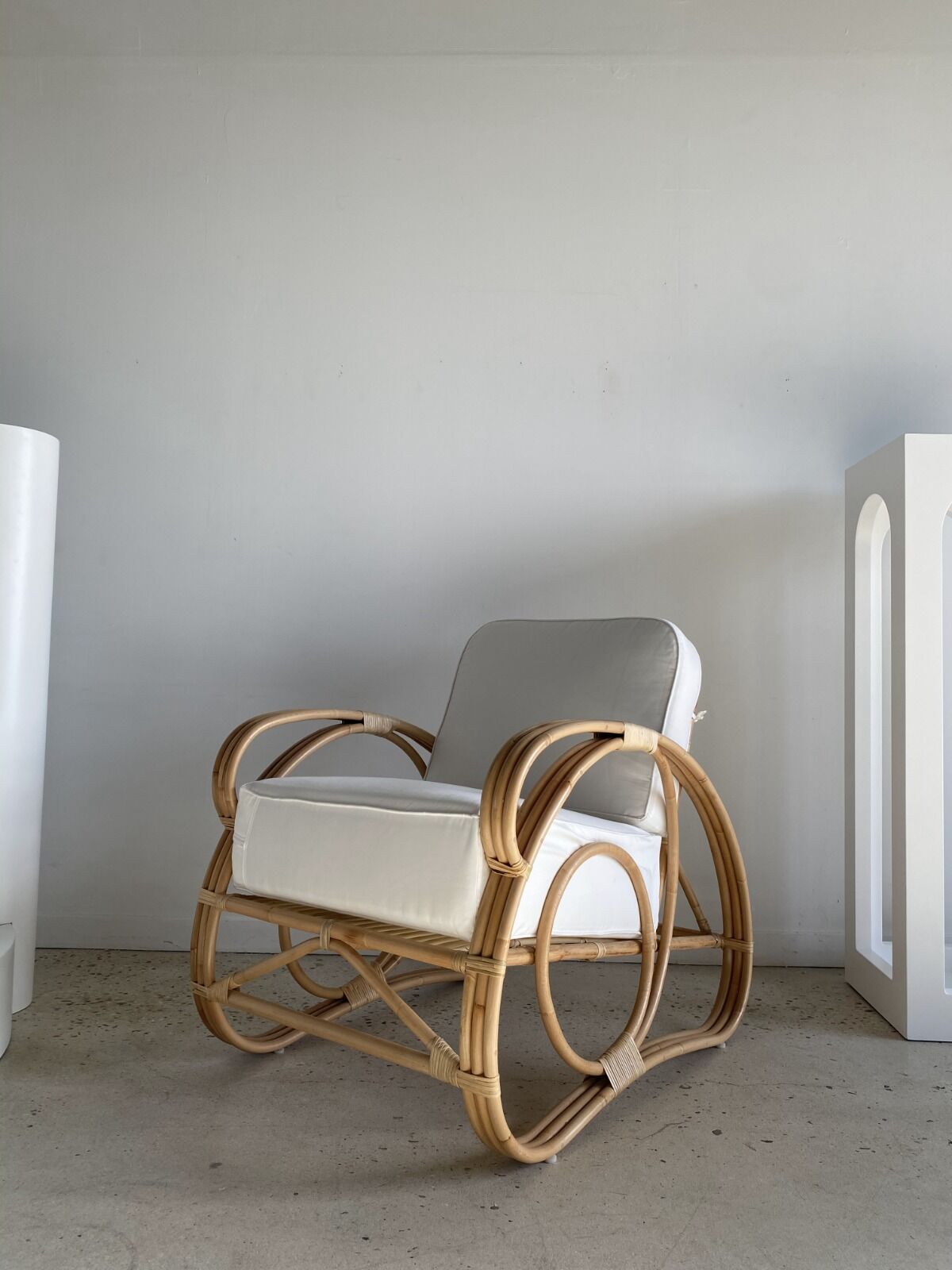 Large rattan rest chair and white cushions